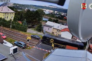 Řidič mercedesu vjel na přejezd před přijíždějícím vlakem, pak horečně manévroval. Zachytila to kamera - Novinky